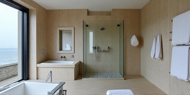 Serene coastal-inspired bathroom with natural stone textures and a custom-built, oversized shower enclosure.